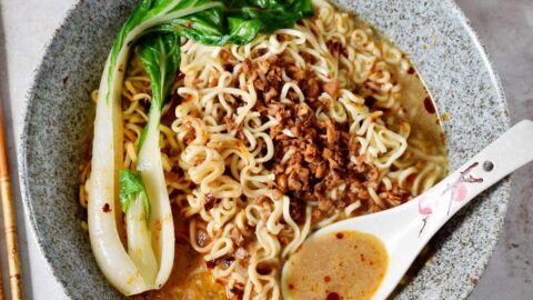 Tantanmen ramen with bok choy in bowl with spoon