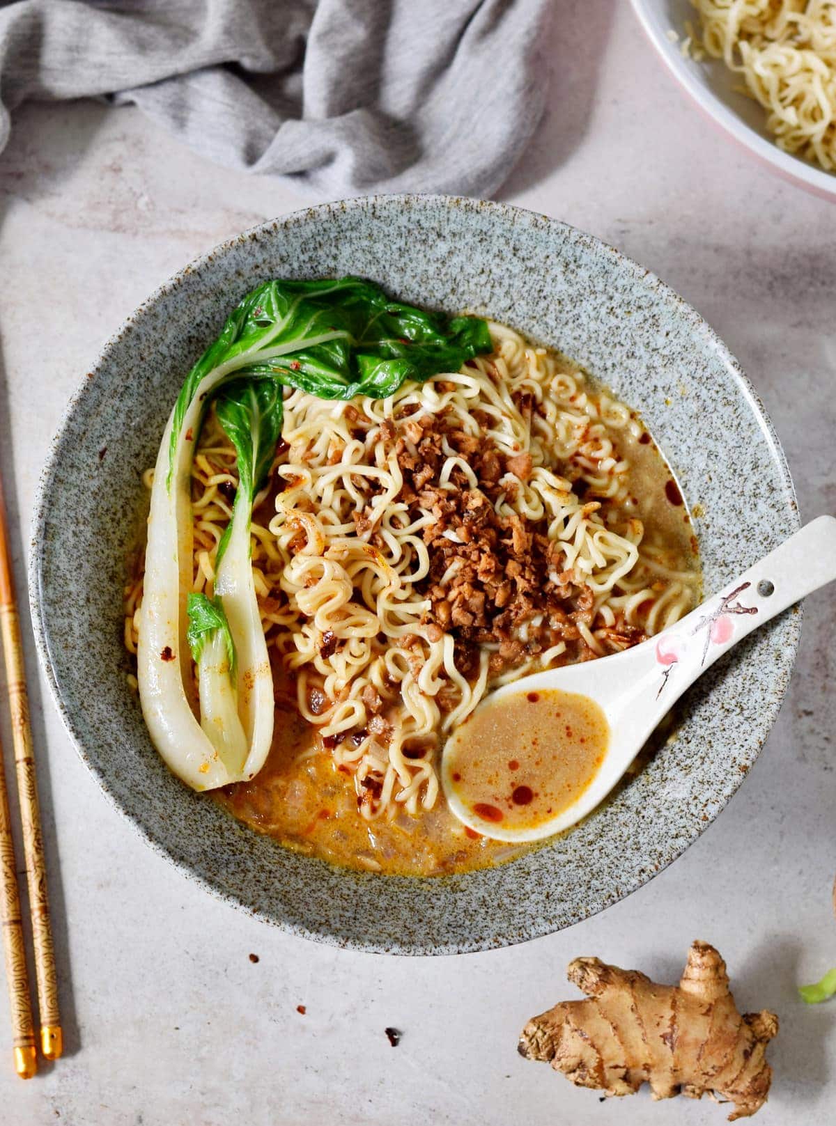 Tantanmen ramen with bok choy in bowl with spoon
