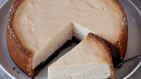 Whole dairy-free cheesecake with slice on large plate