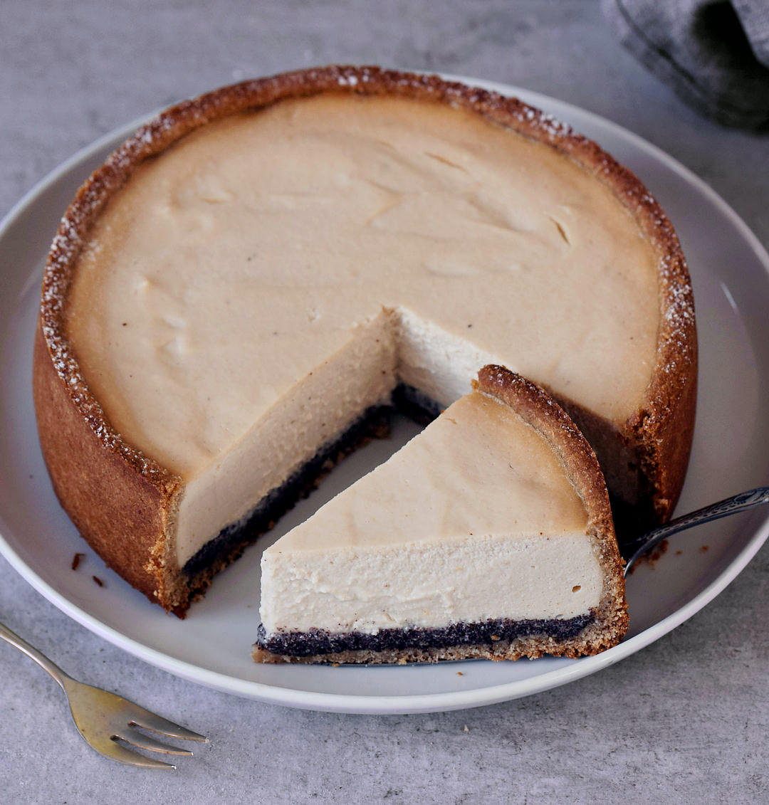Whole dairy-free cheesecake with slice on large plate