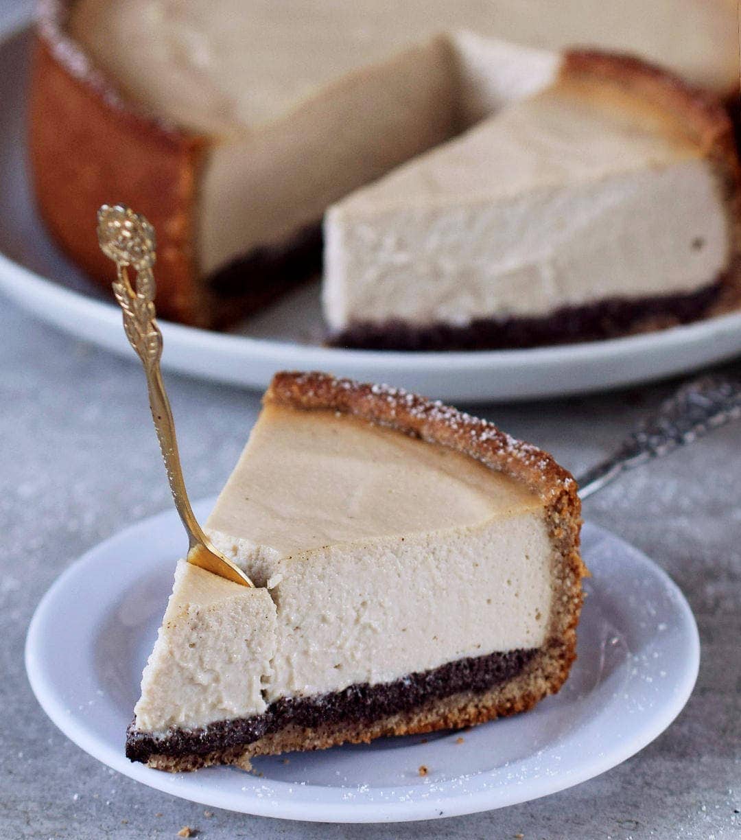 fork submerged in a piece of baked vegan cheesecake