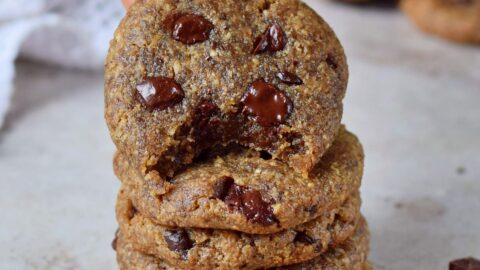hand grabbing coconut sugar cookies from stack