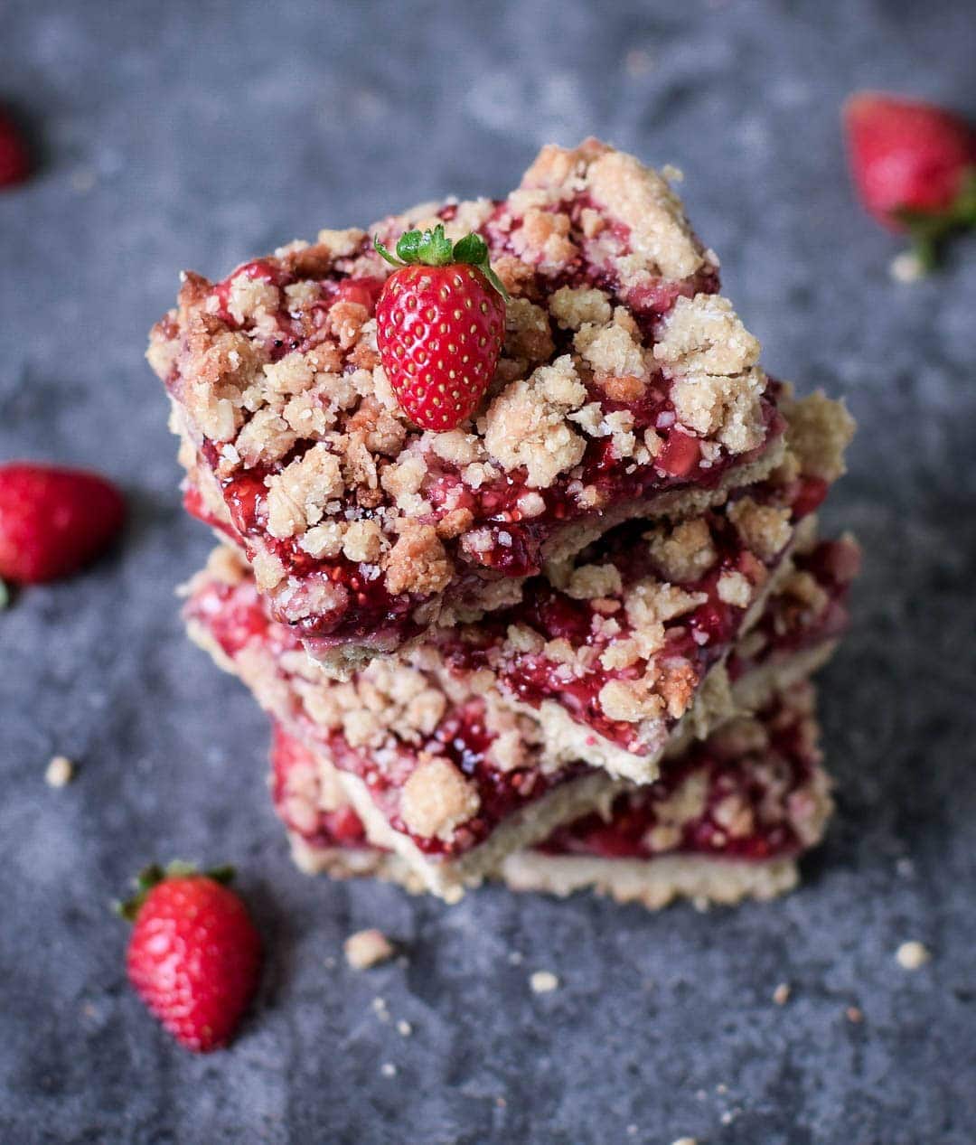 stack of 4 crumble bars with strawberries