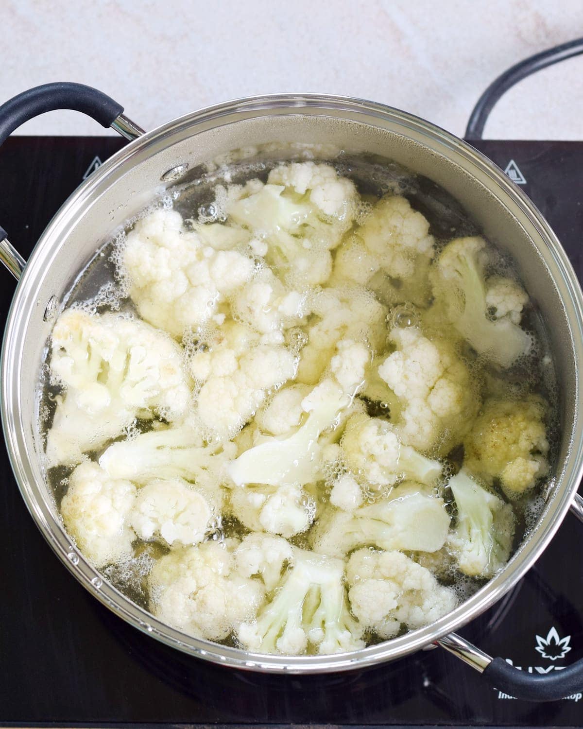 cauliflower boiling in pot with water