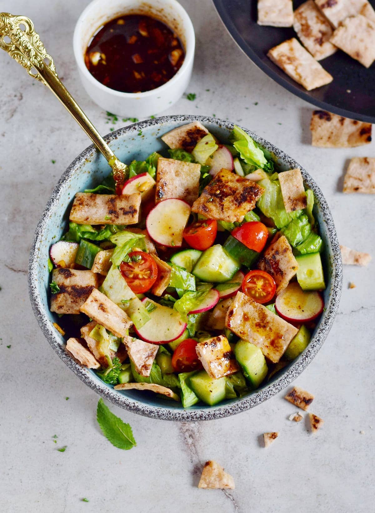 fattoush salad in bowl with spoon