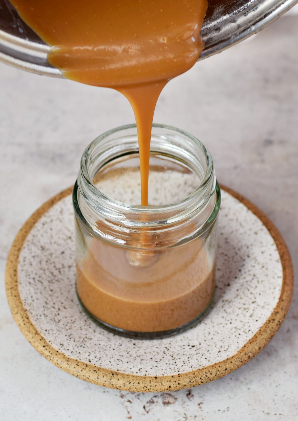 pouring caramel in glass jar