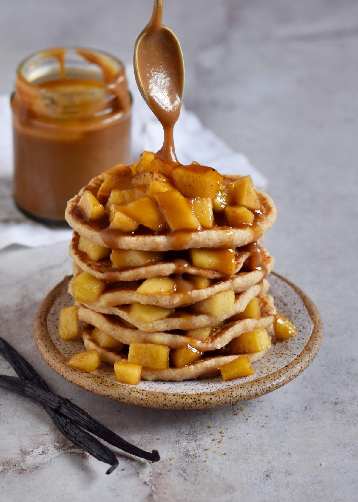 stack of applesauce pancakes with caramel sauce