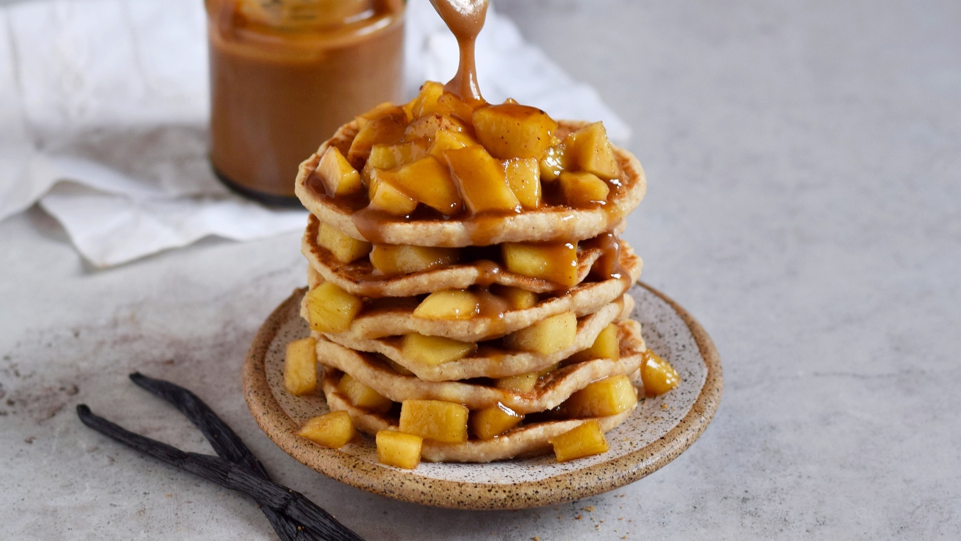 stack of vegan pancakes with apple topping