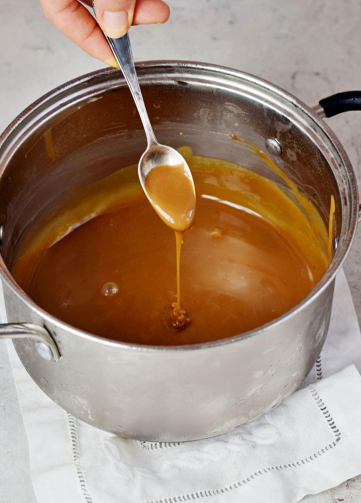vegan caramel sauce in pot with spoon