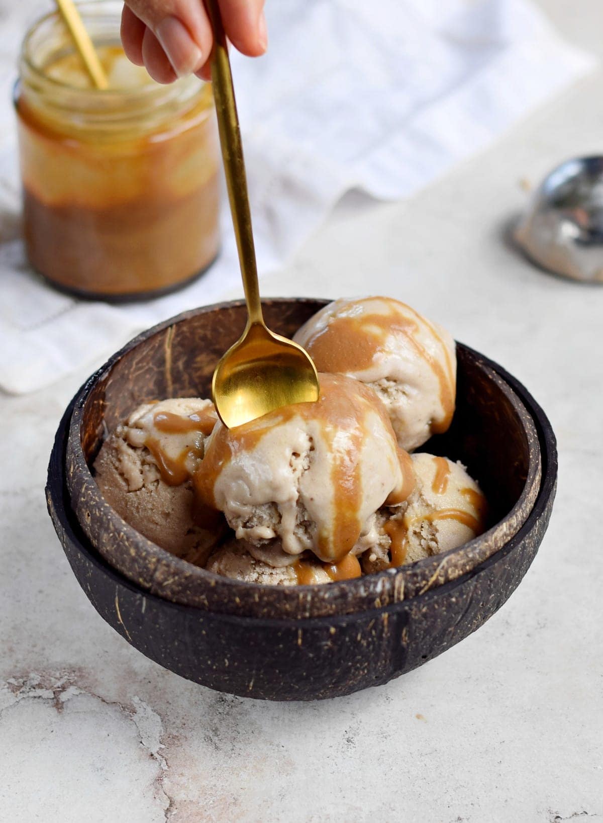 vegan ice cream in coconut bowl with spoon