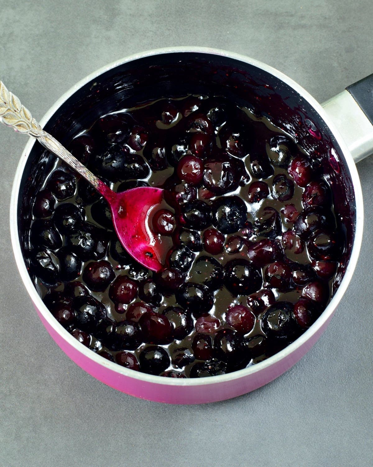 blueberry compote in pink saucepan