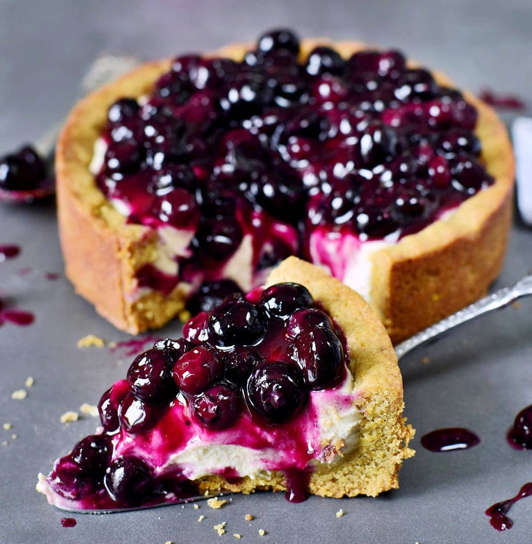 close-up of a creamy pie topped with blueberry compote