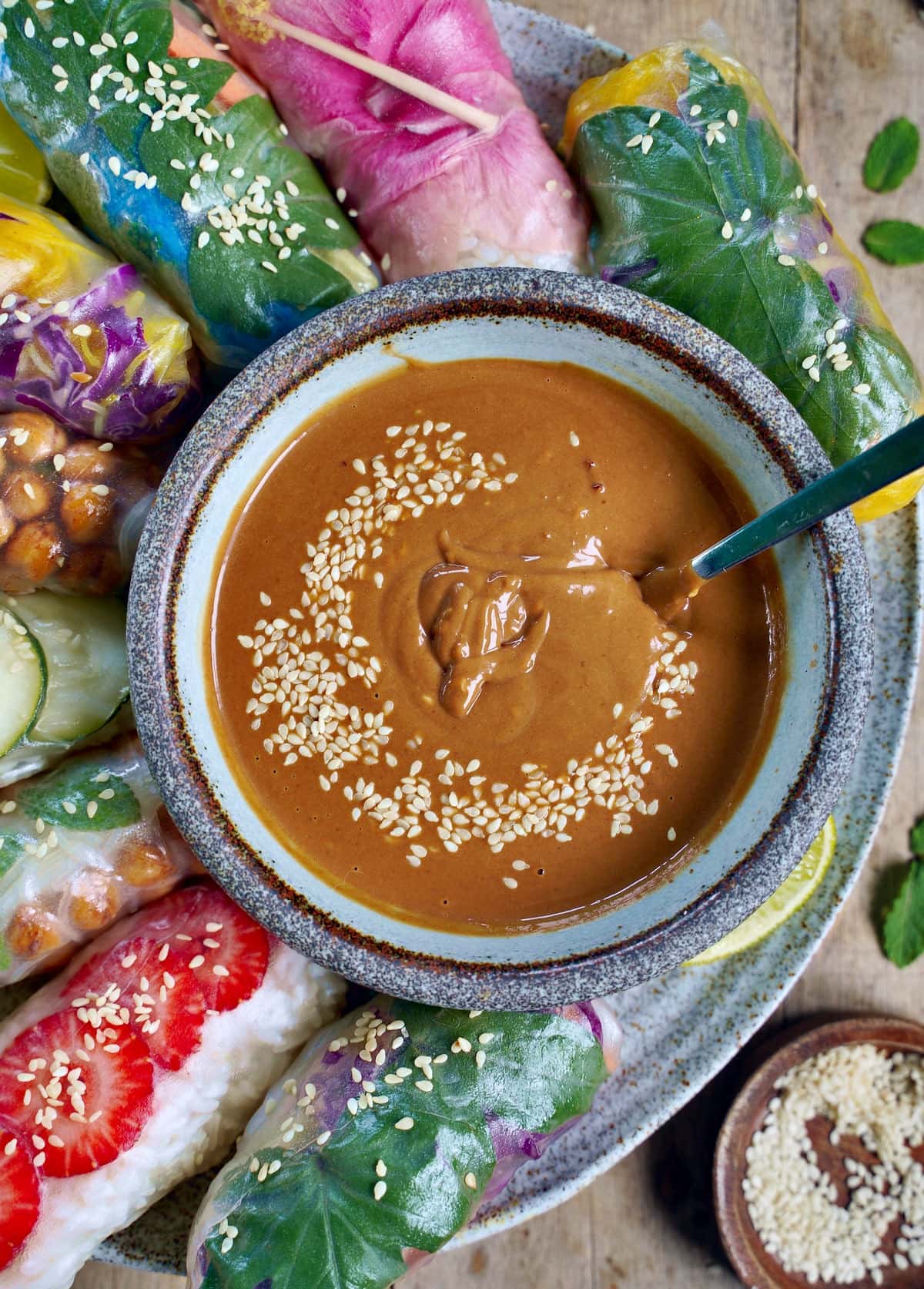 close-up of peanut sauce with summer rolls