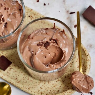 close-up of vegan chocolate mousse in glass with spoon