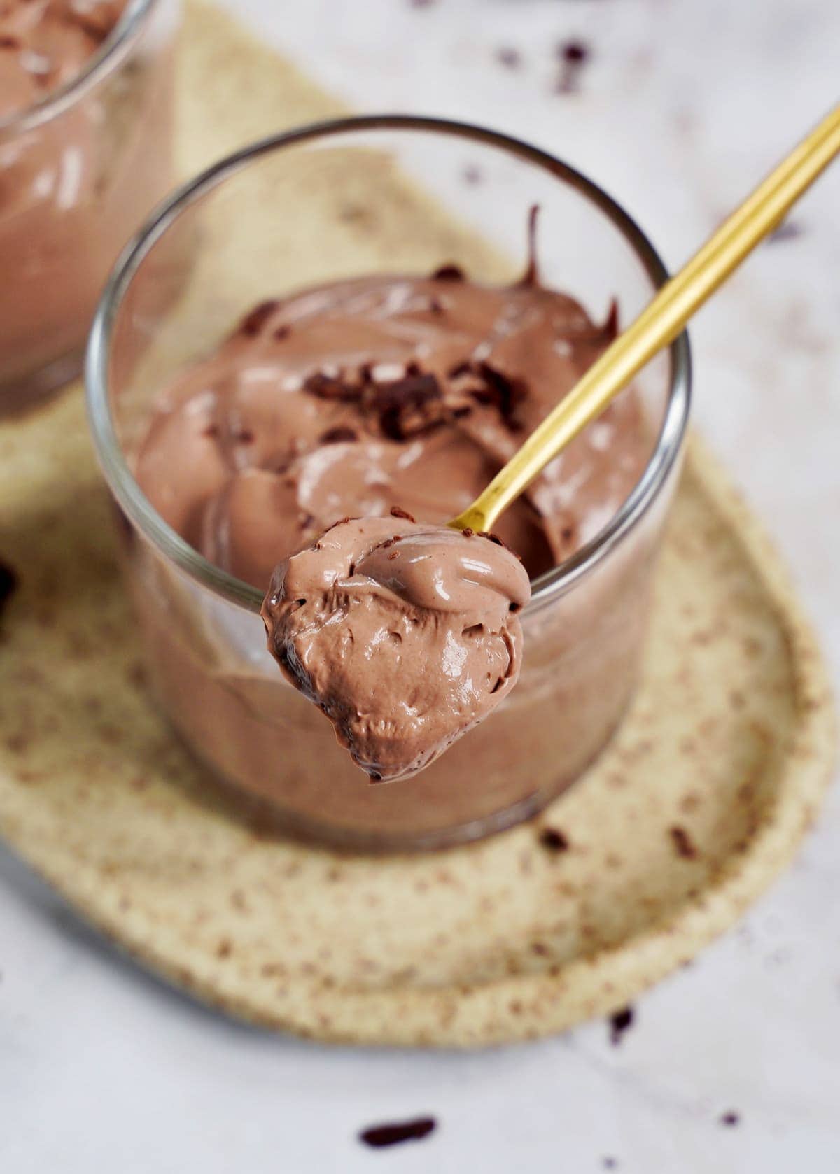 spoon with dairy-free chocolate mousse on top of jar