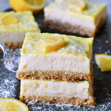 stack of 2 creamy lemon cheesecake bars from the side