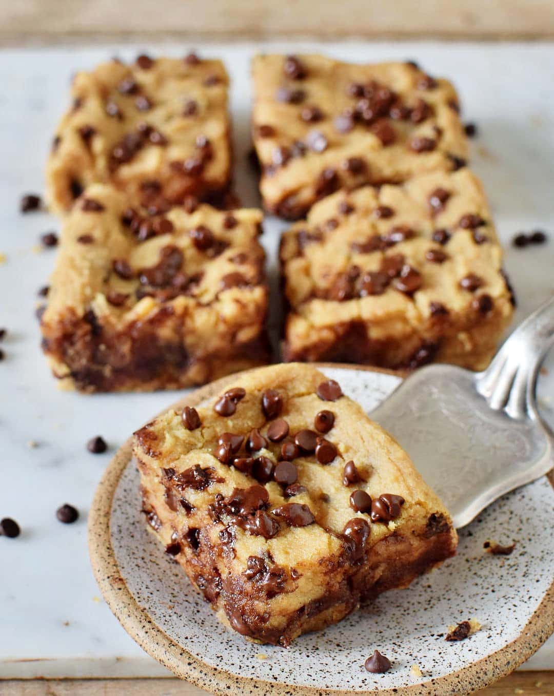 flourless blondies with chocolate chips, one on a small plate