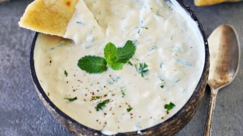 yogurt sauce in bowl with pita chips