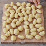 Homemade gluten-free vegan gnocchi before cooking on a cutting board