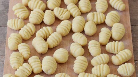Homemade gluten-free vegan gnocchi before cooking on a cutting board