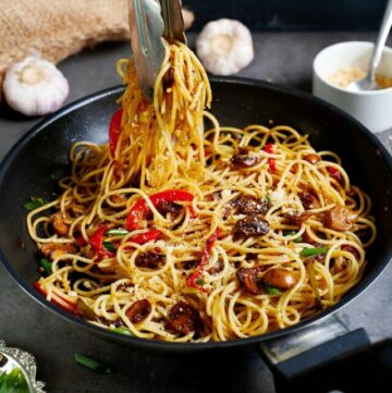 cropped-garlic-noodles-in-black-skillet-with-veggies-and-tongs.jpg