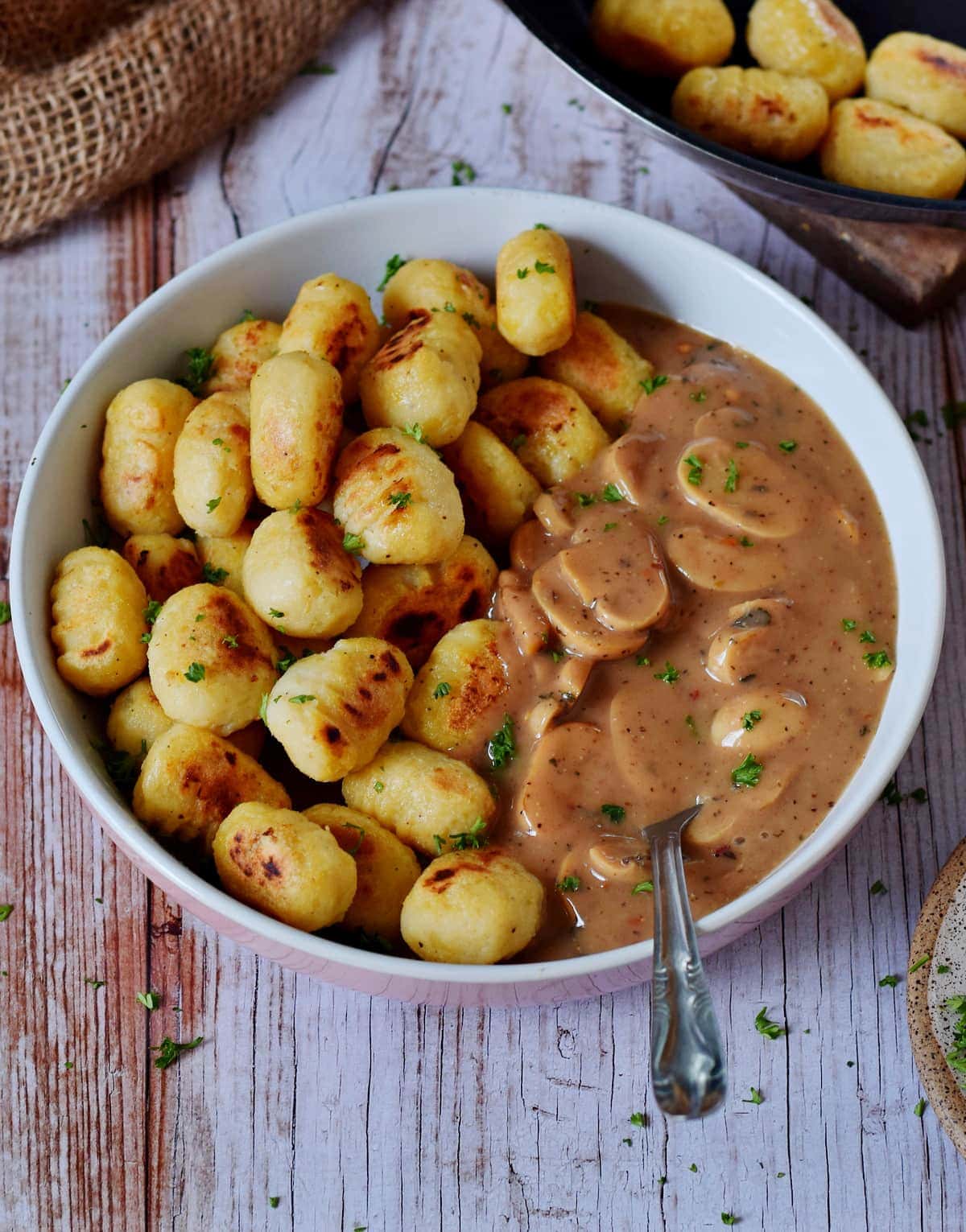 gnocchi in bowl with mushroom Stroganoff from side