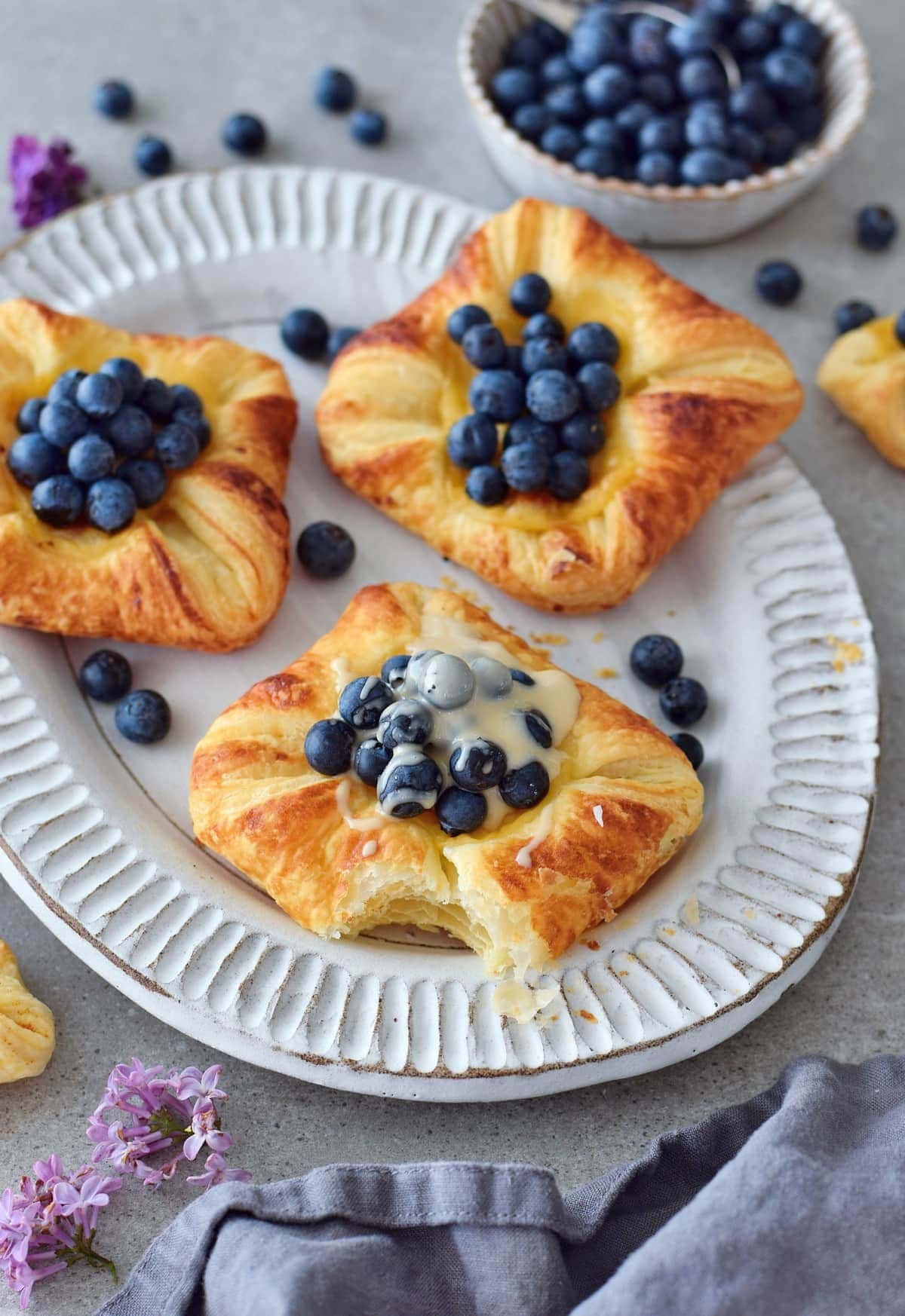 Danish pastry with cashew butter on plate with blueberries