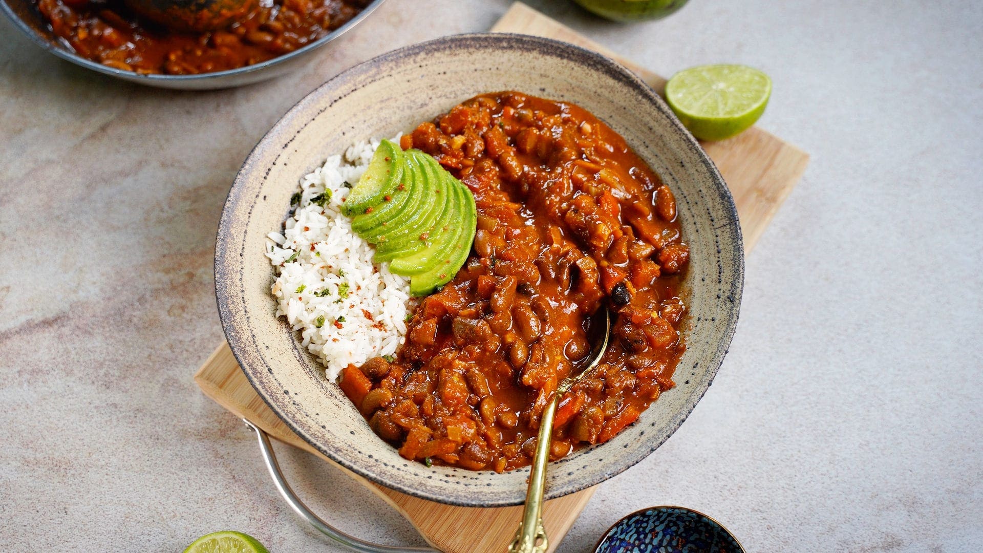 horizontal shot of chili sin carne in bowl with rice and avocado