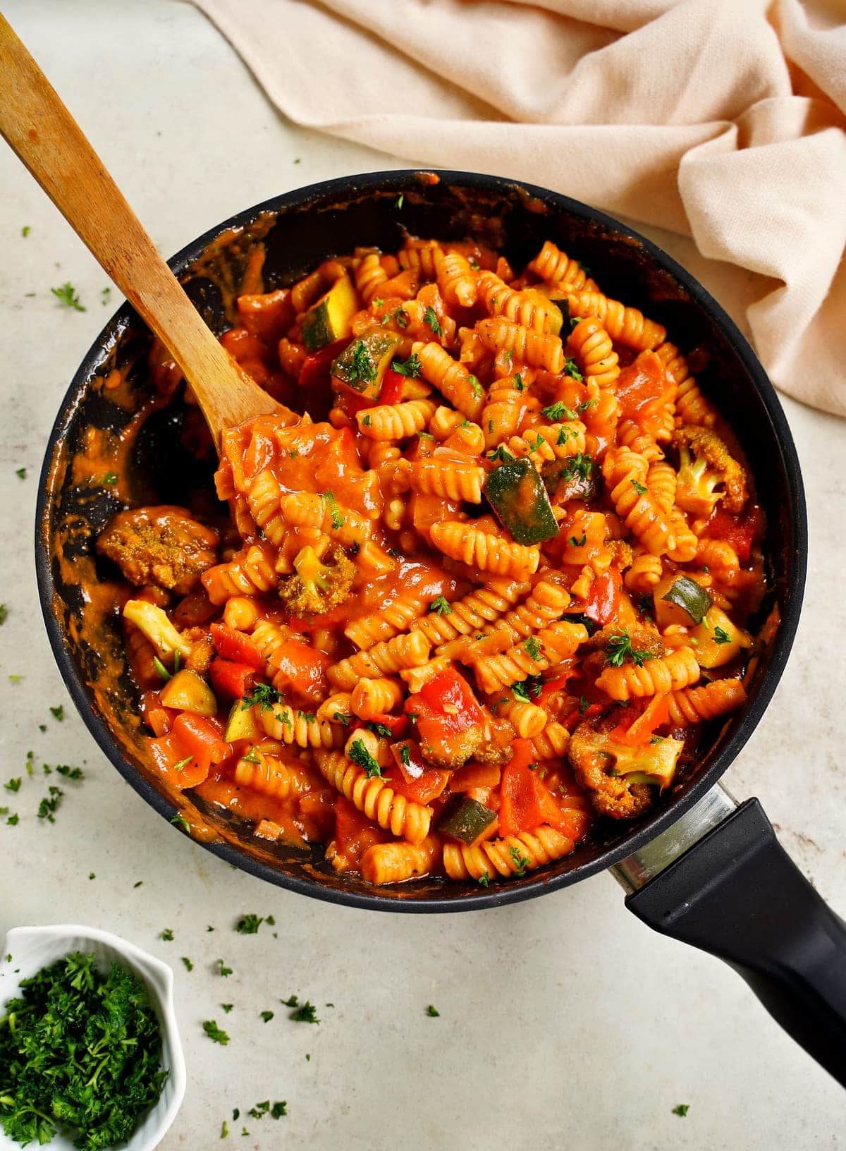 1-pan noodle dish with creamy tomato sauce, vegetables in black skillet