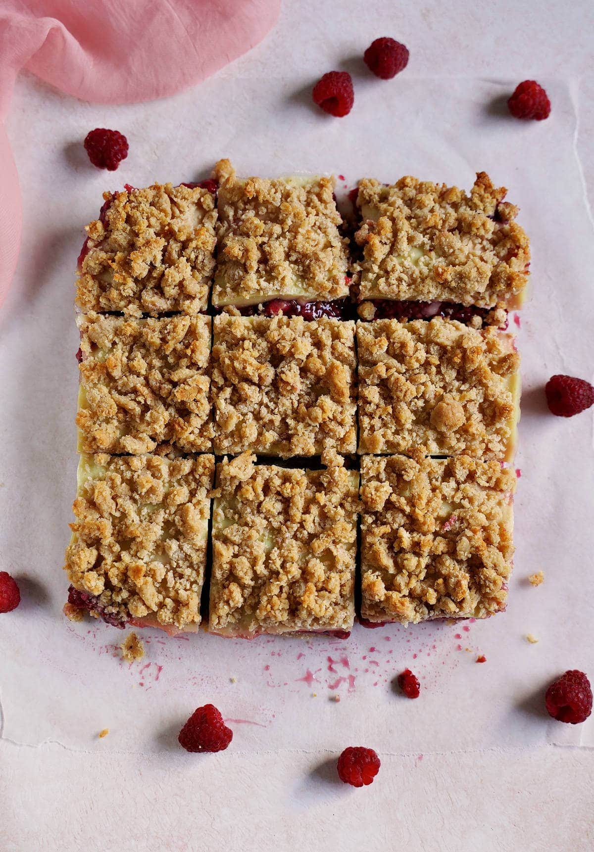 9 slices of crumble cake with raspberries