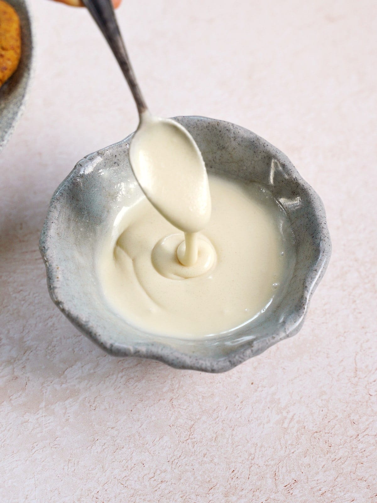 dairy-free refined sugar-free icing in bowl with spoon