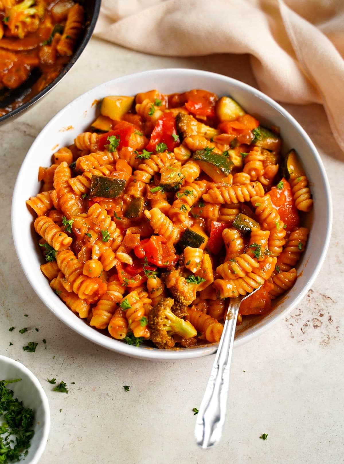 one-pot creamy tomato pasta in bowl with vegetables