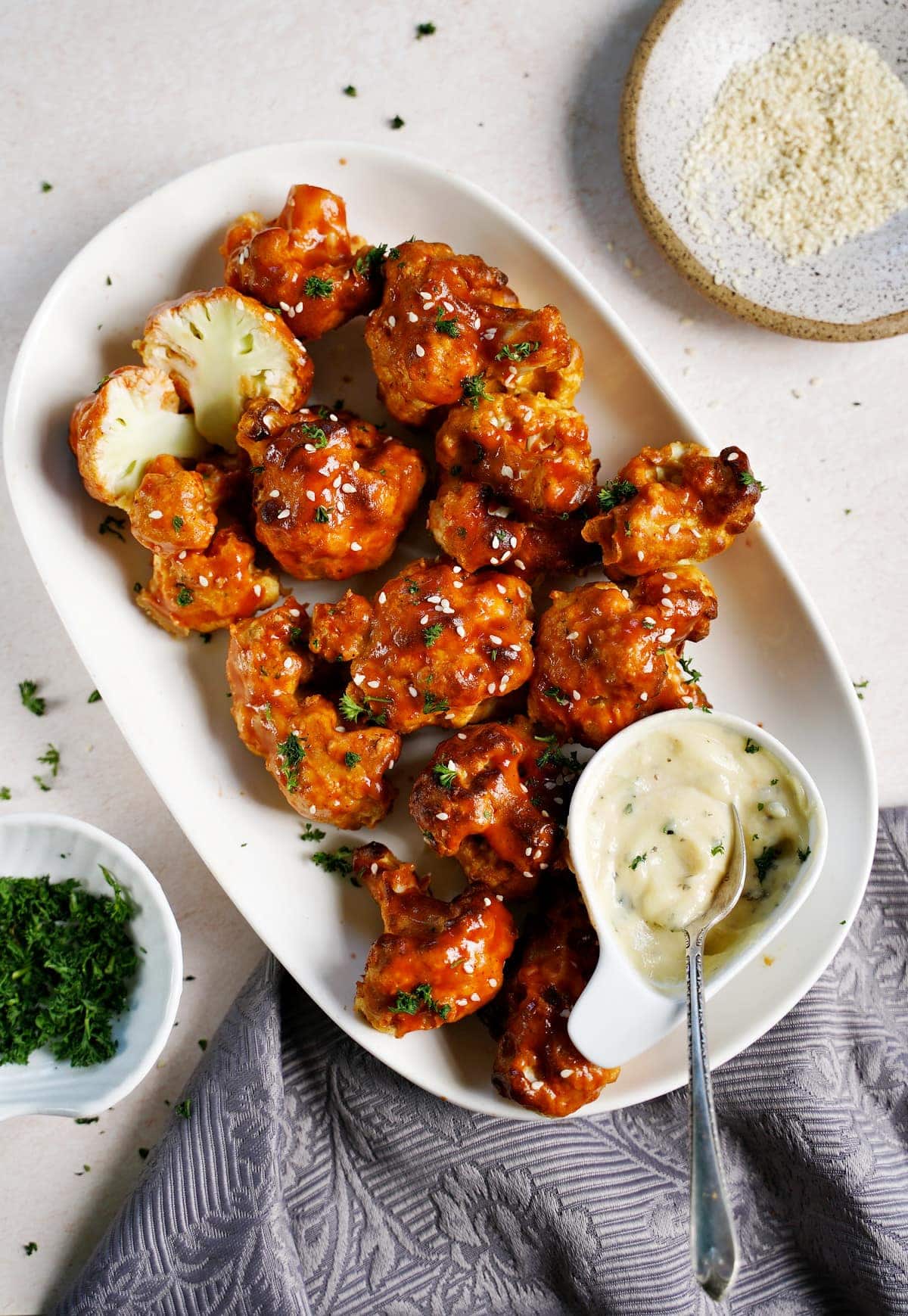 top shot of air fryer Buffalo cauliflower wings with white dip