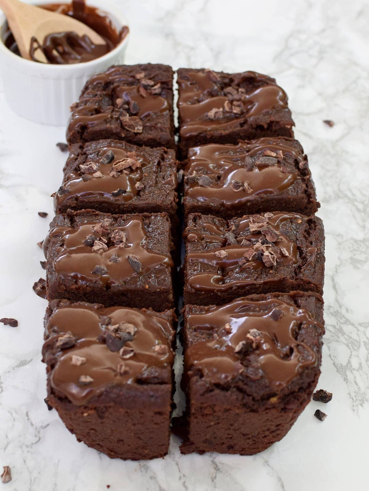 8 thick sweet potato brownies on white marble backdrop