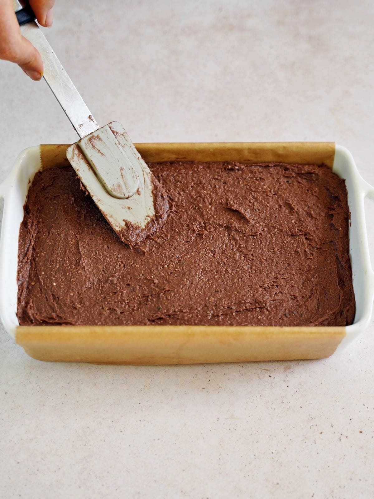brownie batter in white baking pan