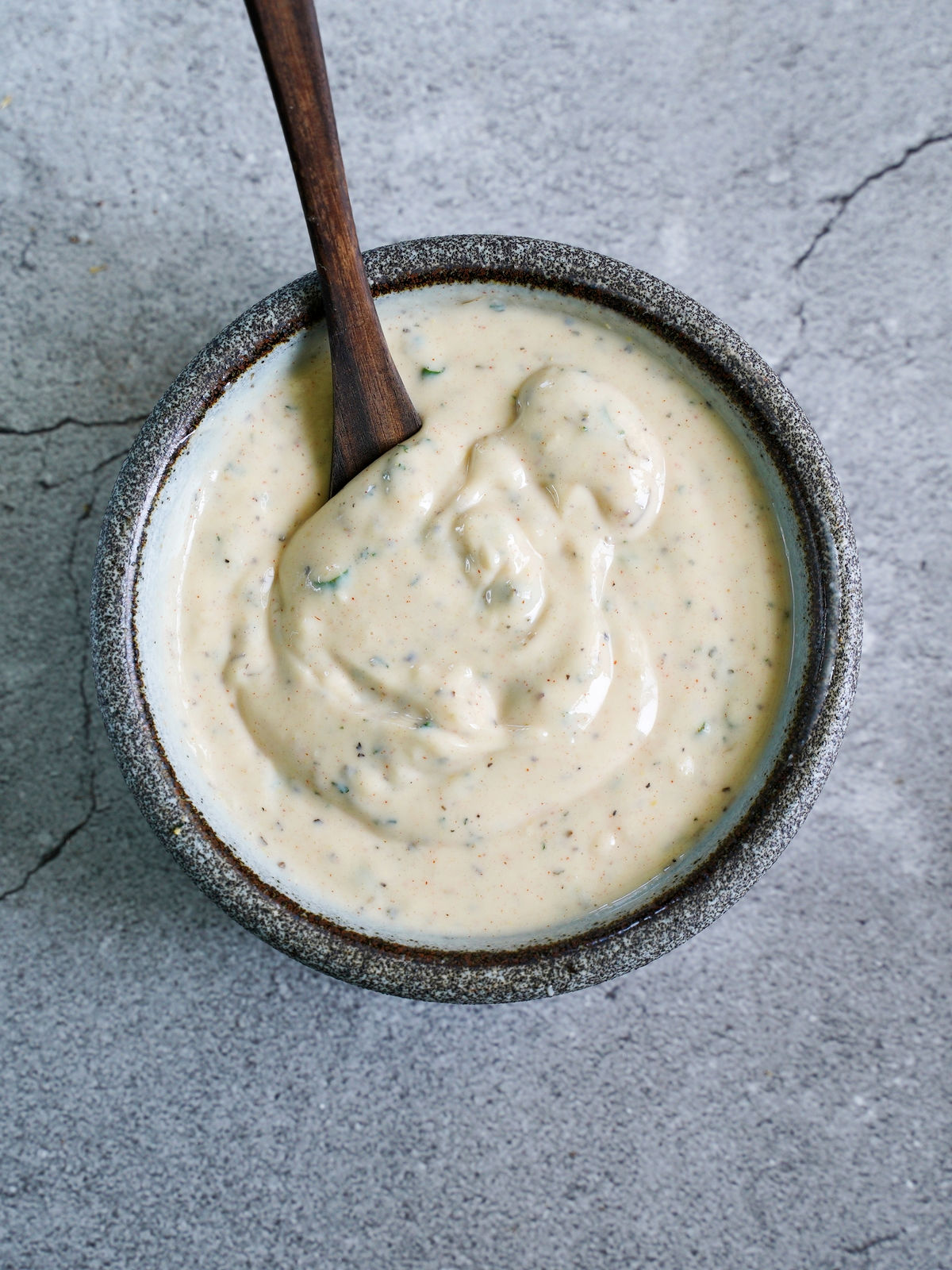 creamy salad dip in bowl with whisk