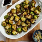 crispy garlic Brussels sprouts on white plate