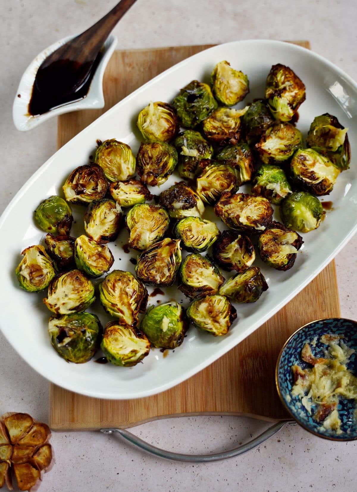 crispy garlic Brussels sprouts on white plate