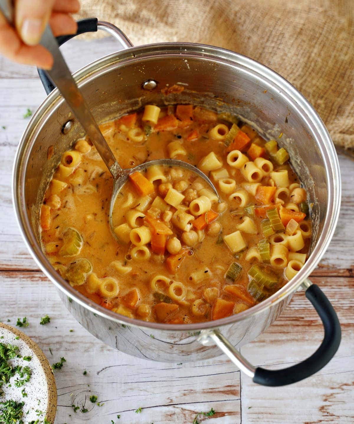 pasta with chickpeas in large pot with ladle