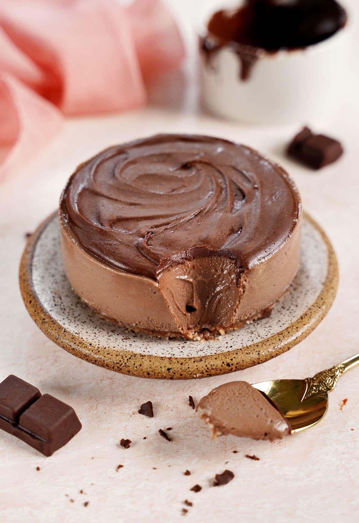 small chocolate mousse cake with spoon on the side