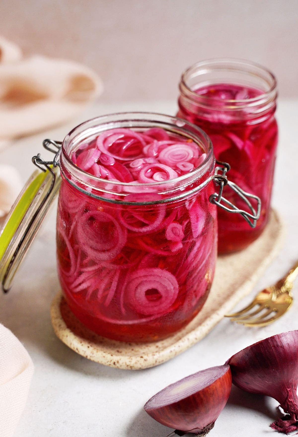 2 open jars filled with pickled red onions