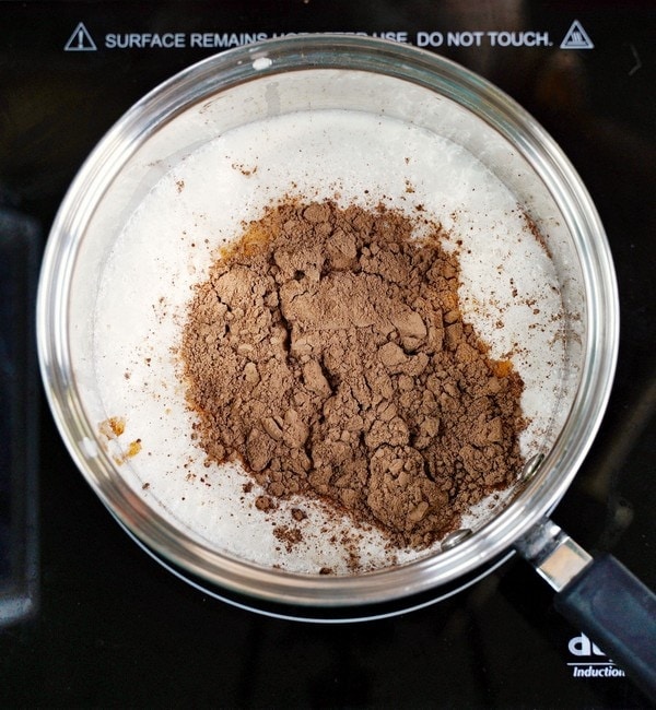 cocoa powder in dairy-free milk in saucepan