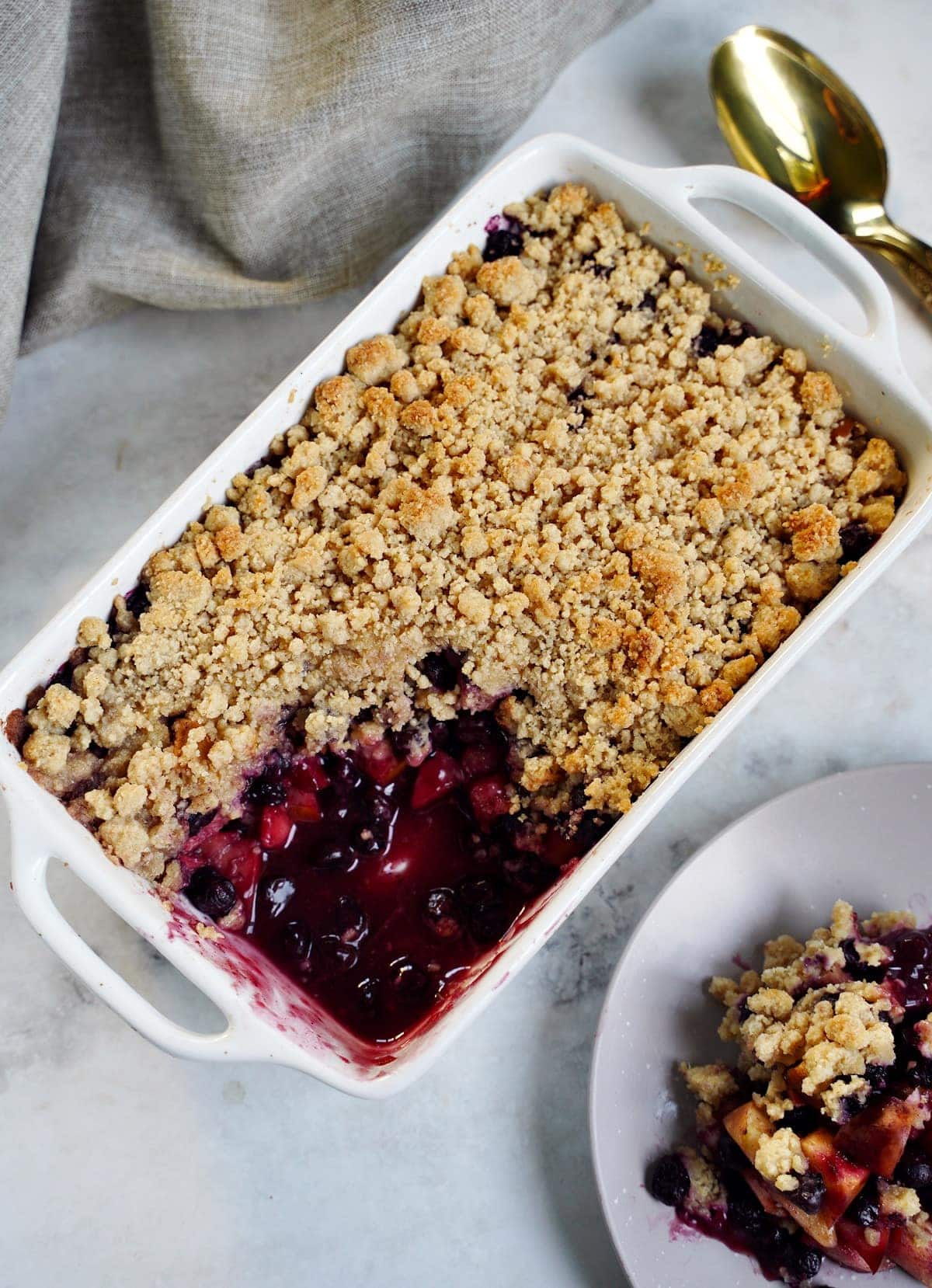 top shot of gluten-free apple blueberry crumble in white pan