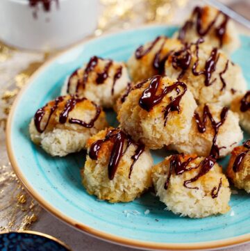 vegan coconut with chocolate drizzle macaroons on blue plate