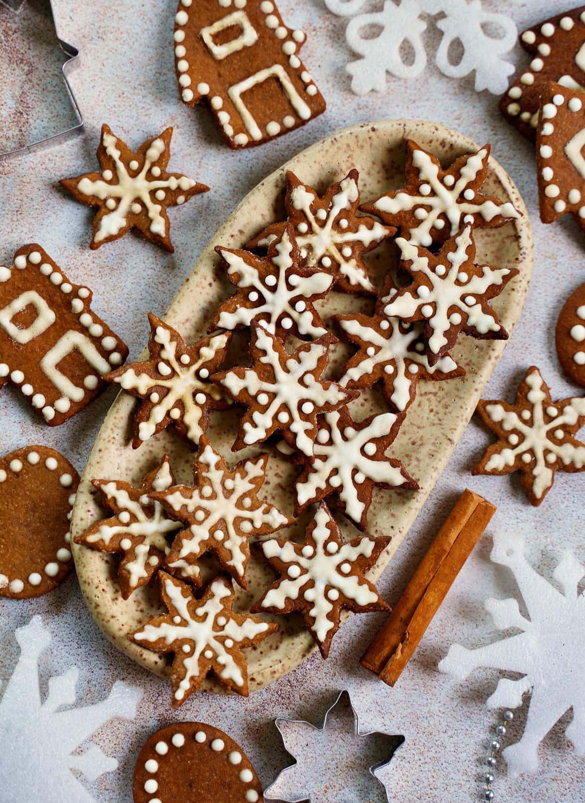 vegan gingerbread cookies with icing on ceramic plate