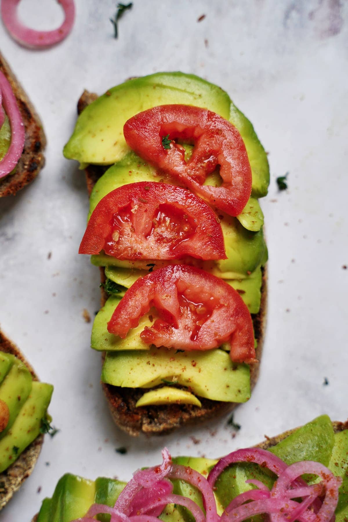 close-up of bread with avo and tomato slices