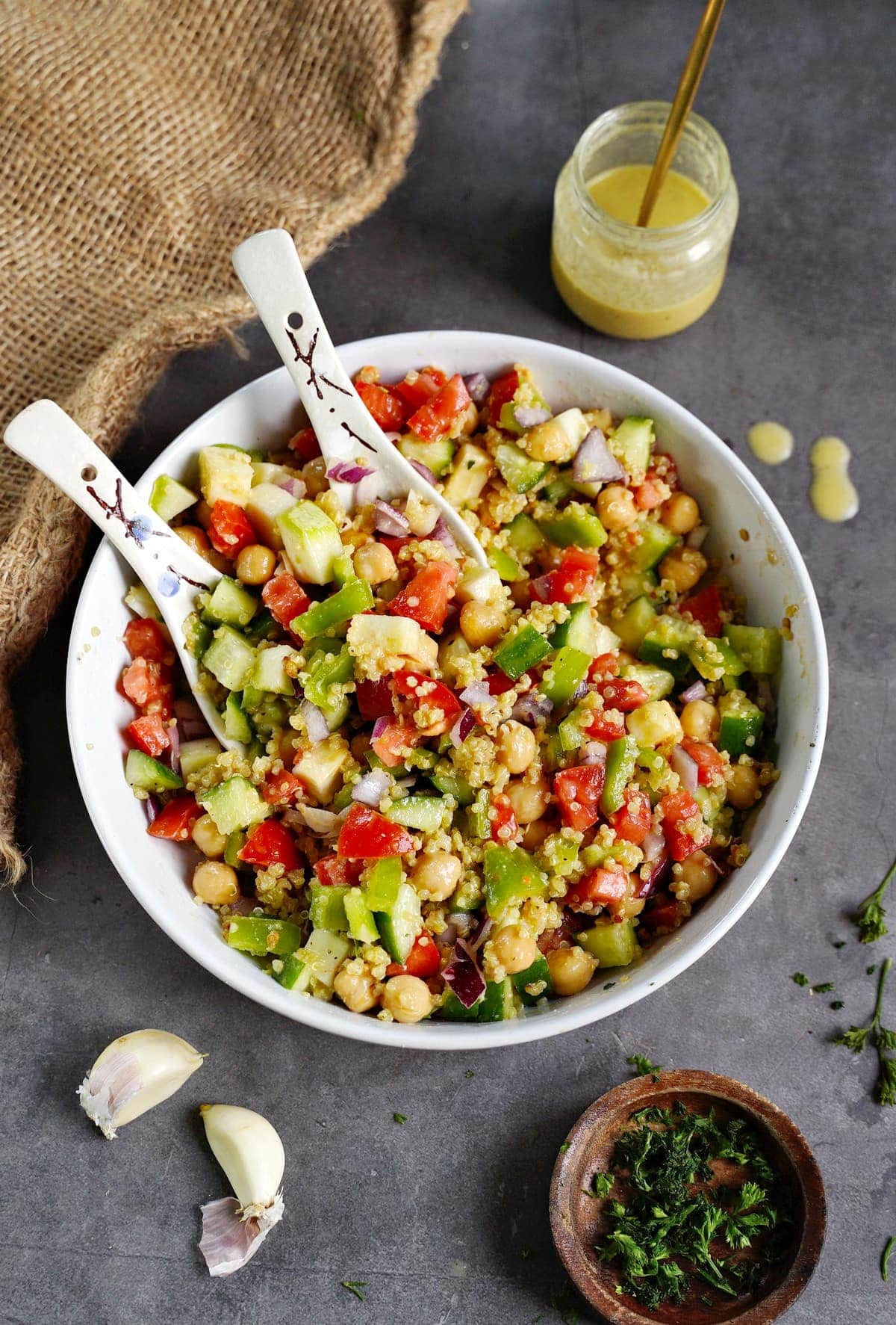 colorful quinoa salad in bowl with spoons