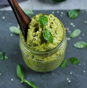 cropped-nut-free-avocado-pesto-in-small-jar-with-wooden-spoon-inside.jpg
