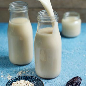 cropped-pouring-homemade-oat-milk-into-bottle.jpg
