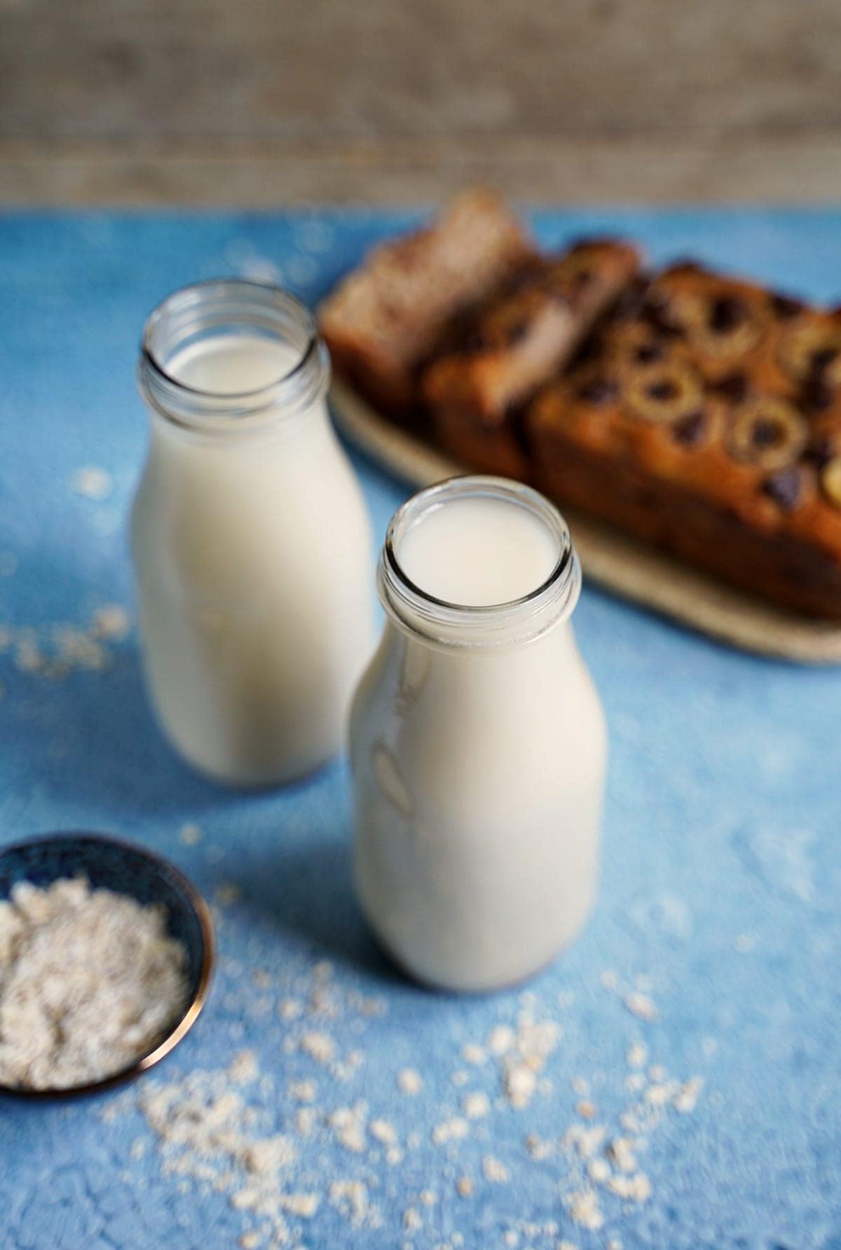 dairy-free mylk in 2 glass jars with banana bread